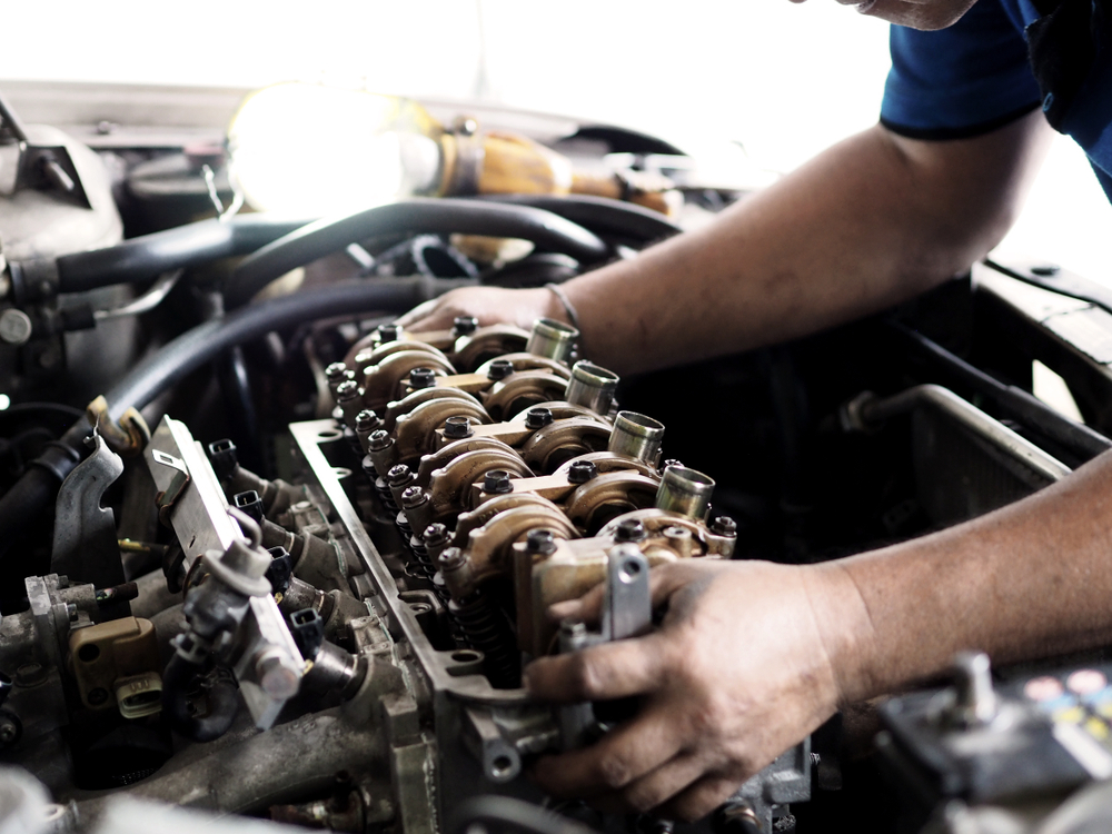 mechanic working on car engine